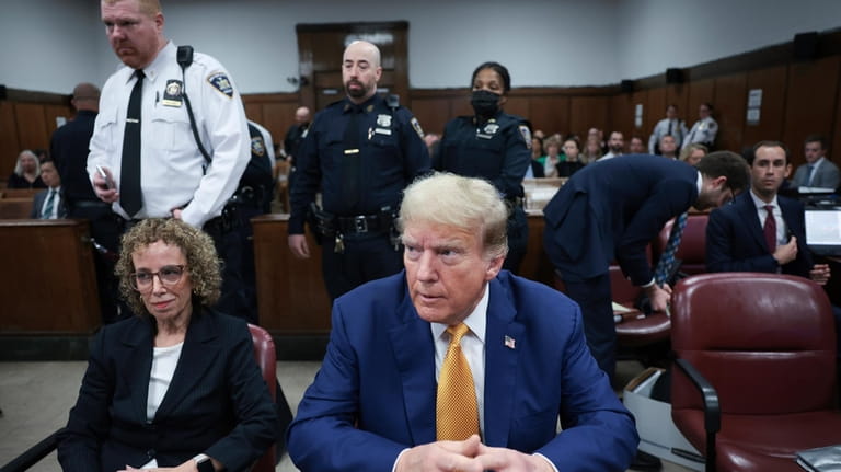 Former President Donald Trump, center, and attorney Susan Necheles, left,...