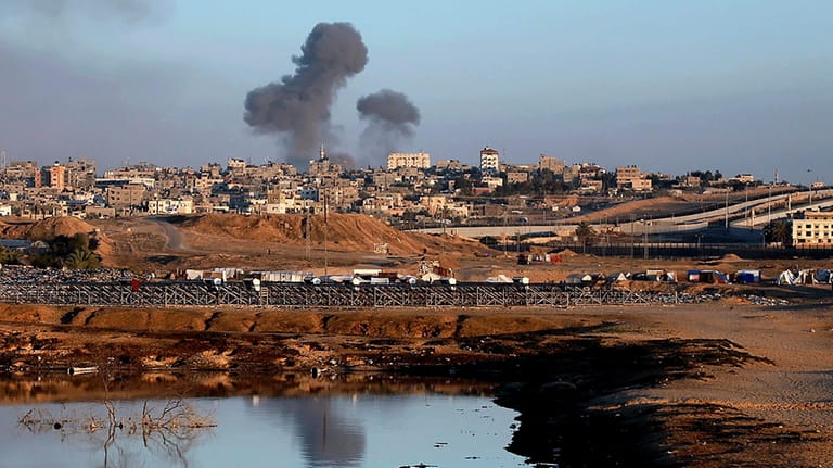 Smoke rises following an Israeli airstrike on buildings near the...