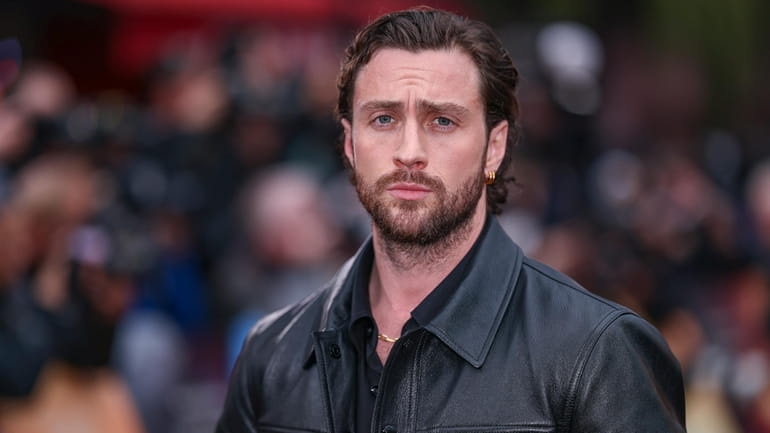 Aaron Taylor-Johnson poses for photographers upon arrival at the World...