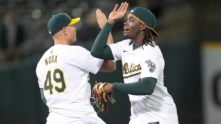 Oakland Athletics' Ryan Noda (49) and Lawrence Butler celebrate after...