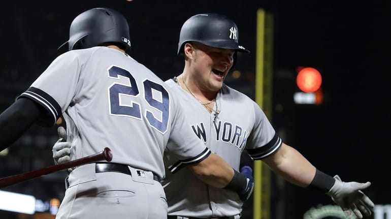 The Yankees' Luke Voit, right, is congratulated by Gio Urshela...