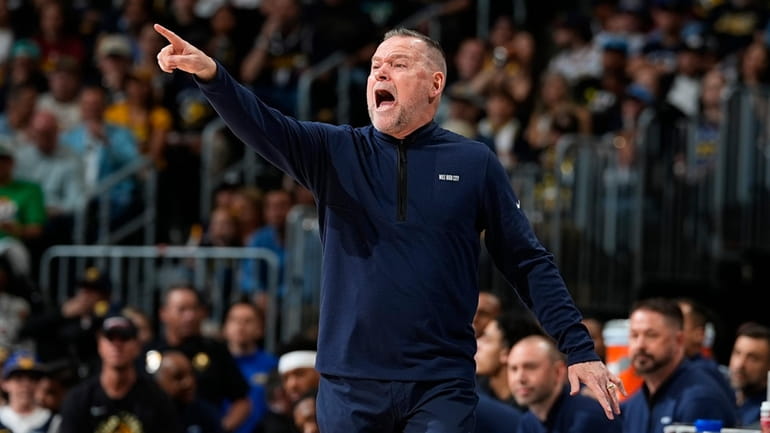 Denver Nuggets head coach Michael Malone directs his team in...