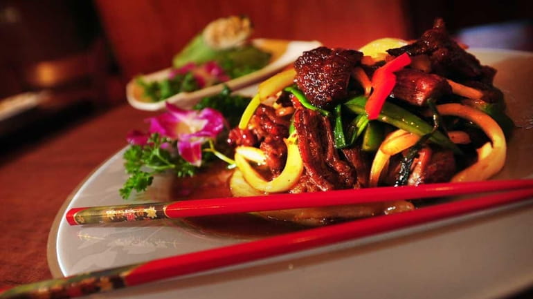 A dish of spicy basil duck is served at Singha...