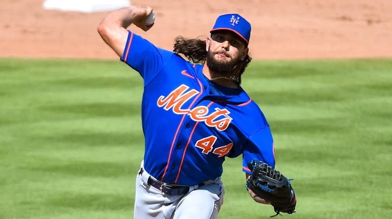 Robert Gsellman of the Mets throws a pitch during a spring...