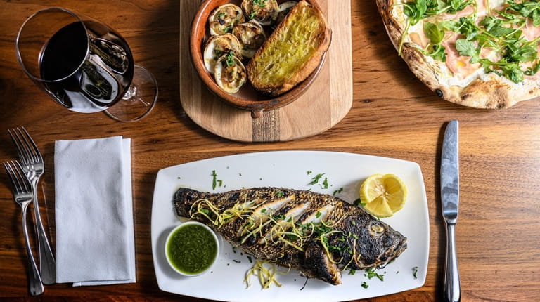 Roasted fish with salsa verde, wood-roasted clams and oven baked...