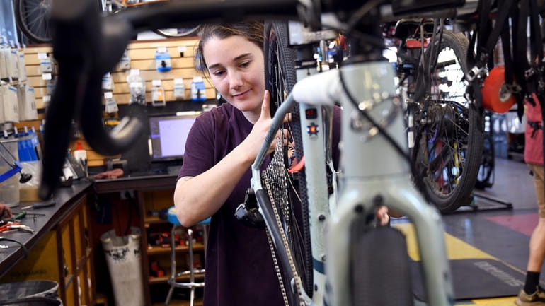 Mechanic Lizzy Thomson works at University Bicycles in Boulder, Colo.,...