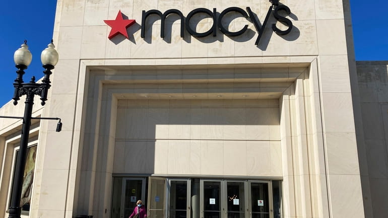 A shopper exits Macy's at the Woodfield Old Orchard Shopping...