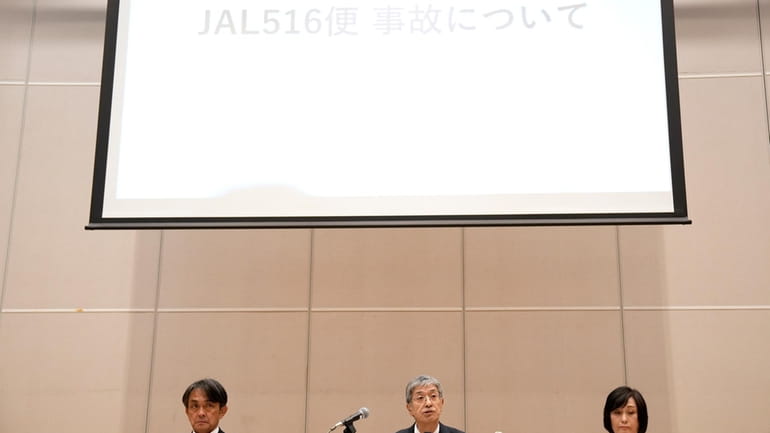 Yuji Akasaka, center, President and CEO of Japan Airlines speaks...