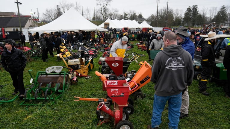 Attendees inspect equipment that will go up for auction during...