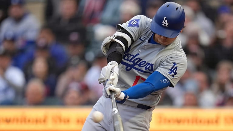Los Angeles Dodgers designated hitter Shohei Ohtani hits a double...