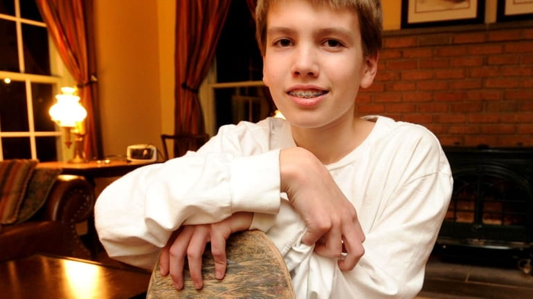 Wes Ackley, 14, poses with his skateboard. (Jan. 21, 2010)