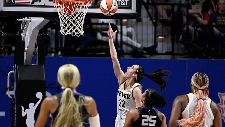 Indiana Fever guard Caitlin Clark (22) scores her first basket...