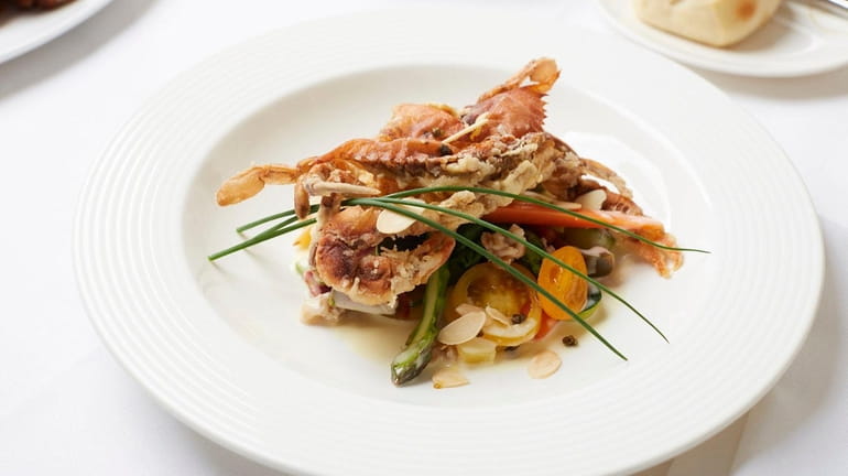 Soft-shell crabs with spring vegetable fricassee are a seasonal special.