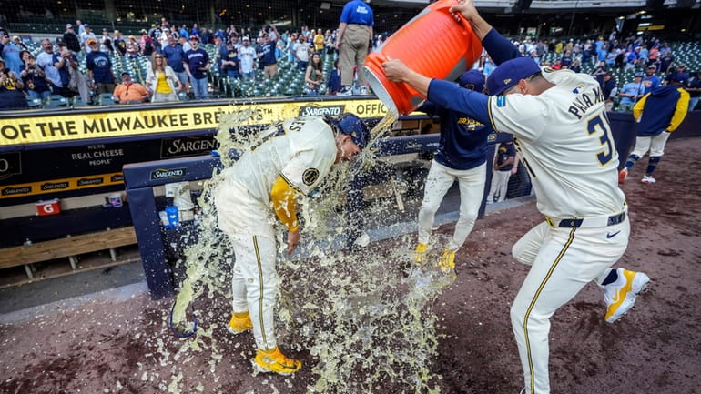Milwaukee Brewers' Willy Adames gets doused after a win over...