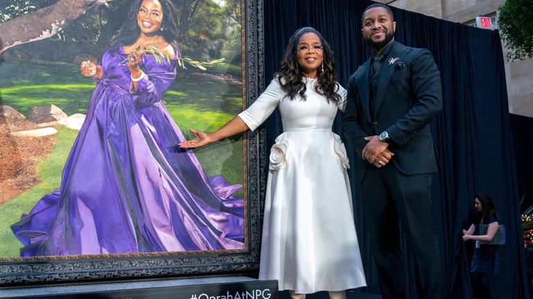 Oprah Winfrey and artist Shawn Michael Warren pose together next...