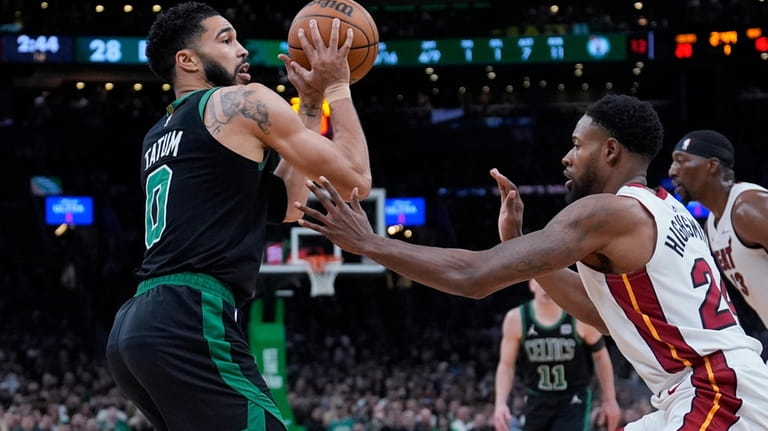 Boston Celtics forward Jayson Tatum (0) looks to pass while...