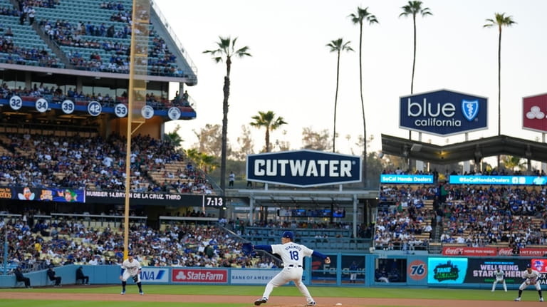 Los Angeles Dodgers starting pitcher Yoshinobu Yamamoto throws to a...