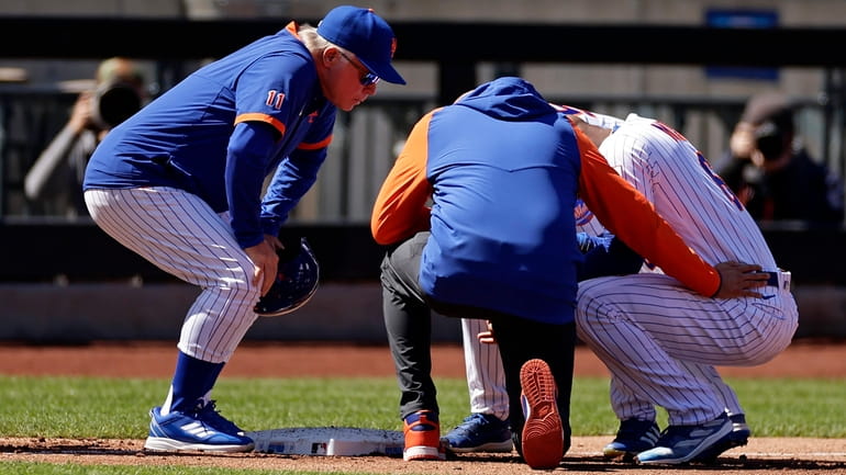 Mets manager Buck Showalter, left, checks on Starling Marte during...