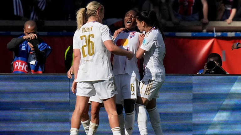 Lyon's Melchie Dumornay, center, celebrates after scoring her side's second...