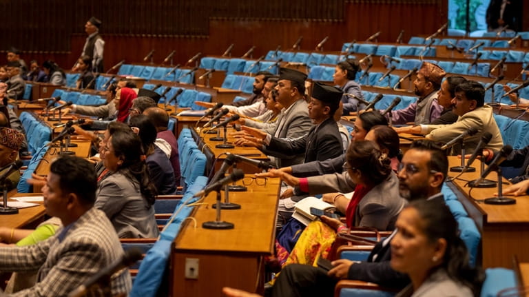 Members of the Nepalese Parliament participate in a vote of...