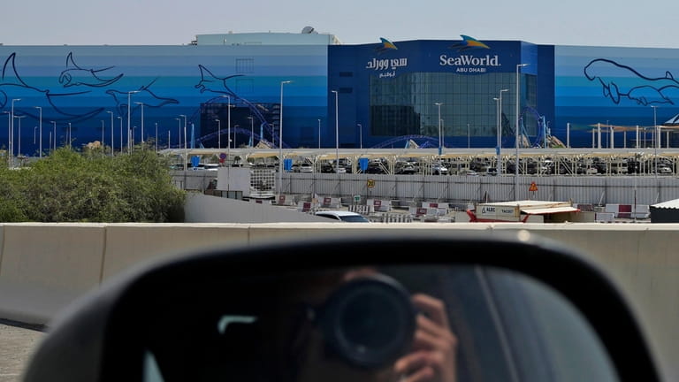 A photographer takes a picture of SeaWorld at the Yas...