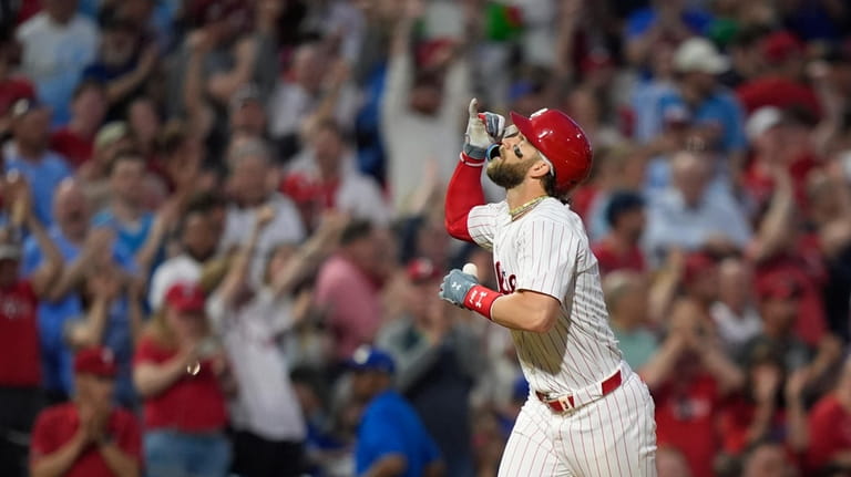 Philadelphia Phillies' Bryce Harper reacts after hitting a grand slam...
