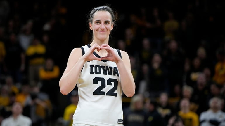 Iowa guard Caitlin Clark makes a heart gesture after the...