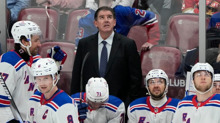 Rangers Peter Laviolette, top center, watches a replay review in...
