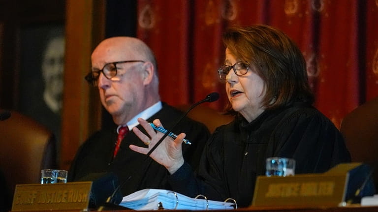 Chief Justice Loretta H. Rush, right, questions an attorney during...