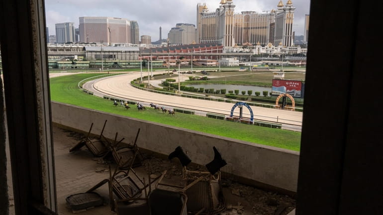 Abandoned tribunes as jockeys compete in last Macao races at...