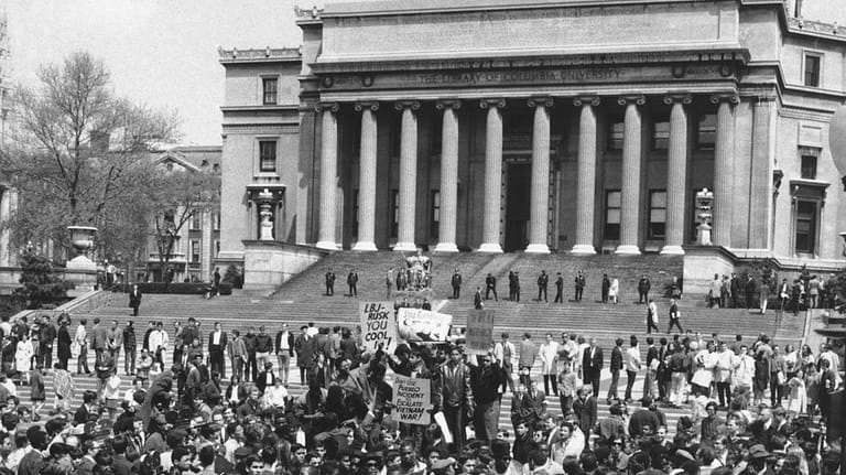 Demonstrators and students protesting the war in Vietnam are seen...