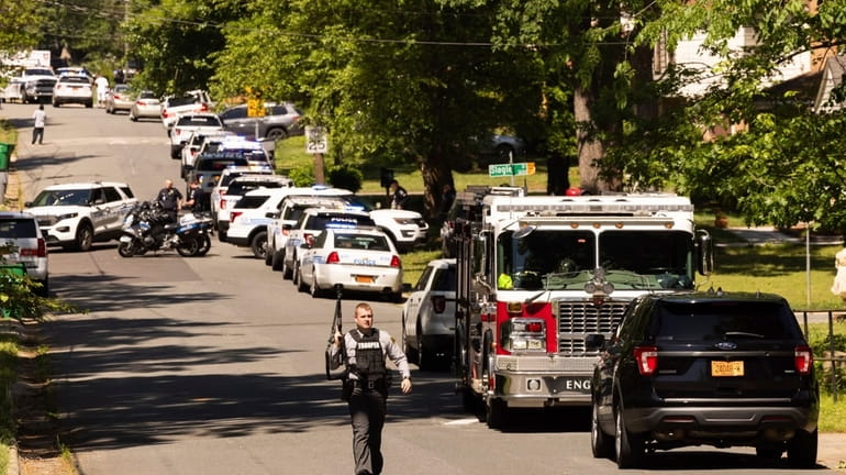 Multiple law enforcement vehicles respond in the neighborhood where several...