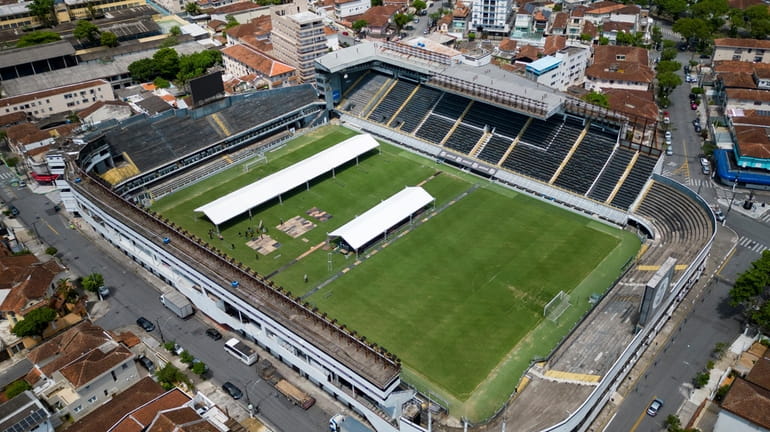 Workers set up tents at the Vila Belmiro stadium, the...