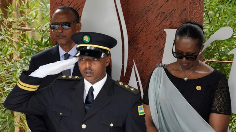 Rwandan President Paul Kagame, background left and his wife, first...