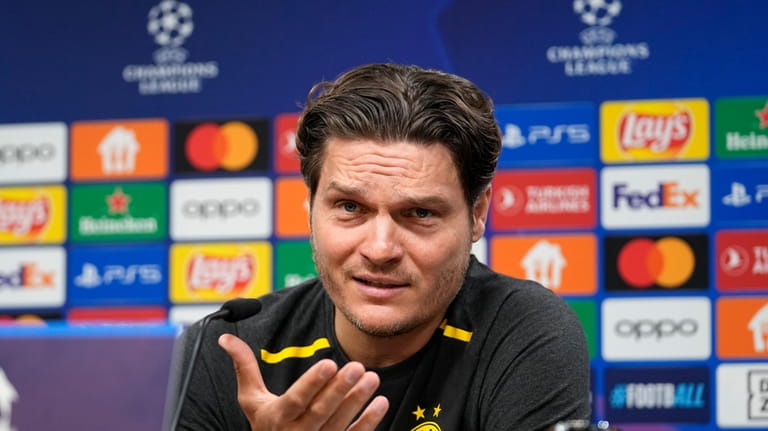 Dortmund's head coach Edin Terzic talks to the media at...