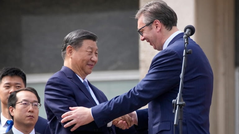 Chinese President Xi Jinping, left, shakes hands with his Serbian...