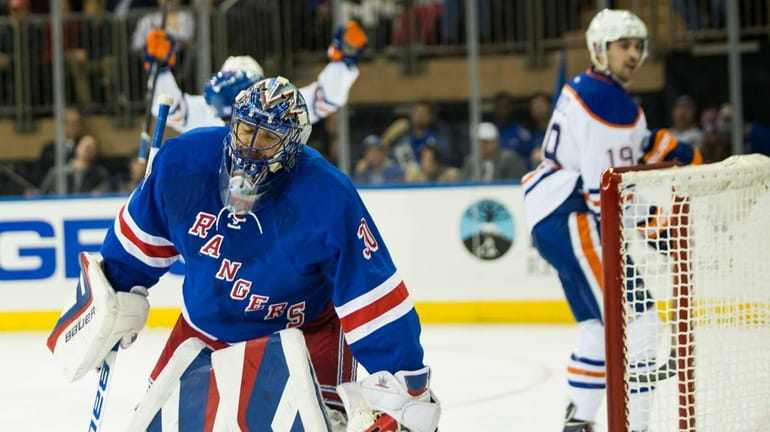 New York Rangers goalie Henrik Lundqvist (30) gives up a...