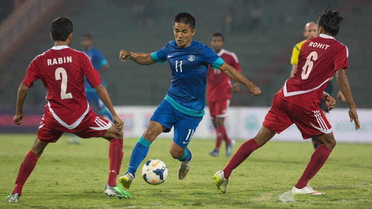 India's Sunil Chhetri, center, advances with the ball during the...