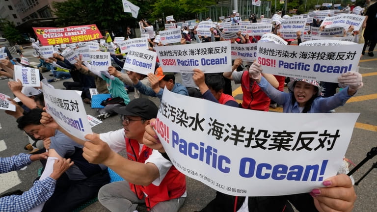 South Korean fishermen stage a rally against the planned release...