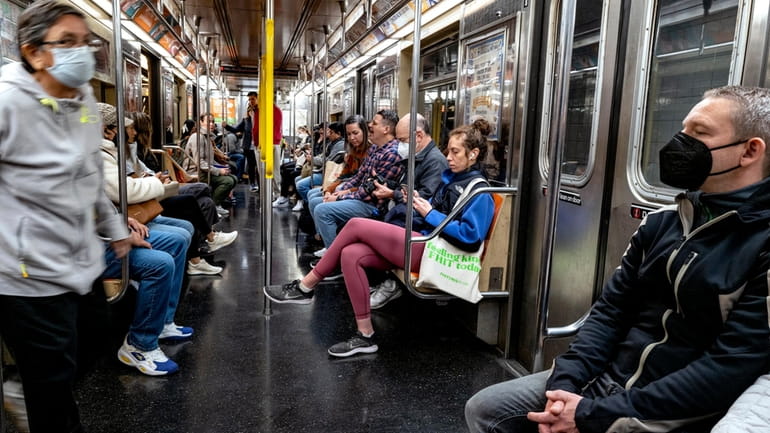 Subway passengers aboard a 1 Train in Manhattan Friday.



	 