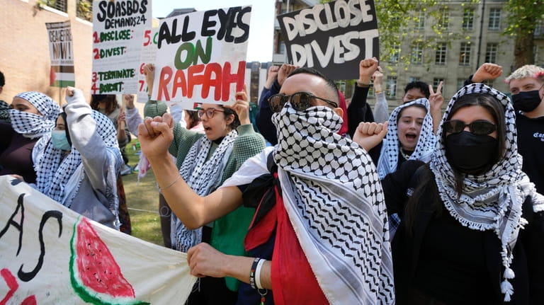 Pro-Palestinian students and demonstrators shout slogans at the campus of...