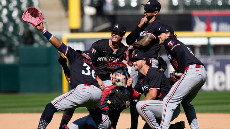 Minnesota Twins players celebrate after the Twins defeated the Chicago...