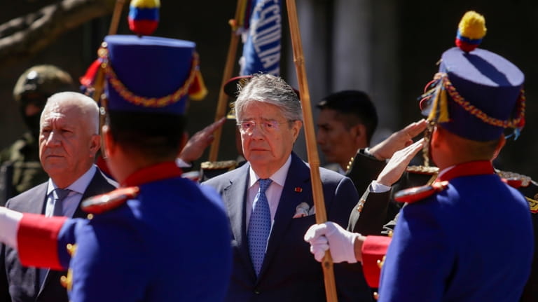 Ecuador's Defense Minister Luis Lara, left, and President Guillermo Lasso,...