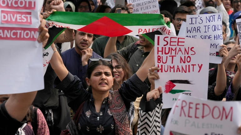 University students take part in rally against the Israeli airstrikes...