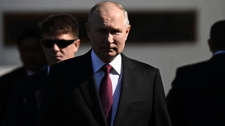 FILE Russian President Vladimir Putin, center, walks to attend a...
