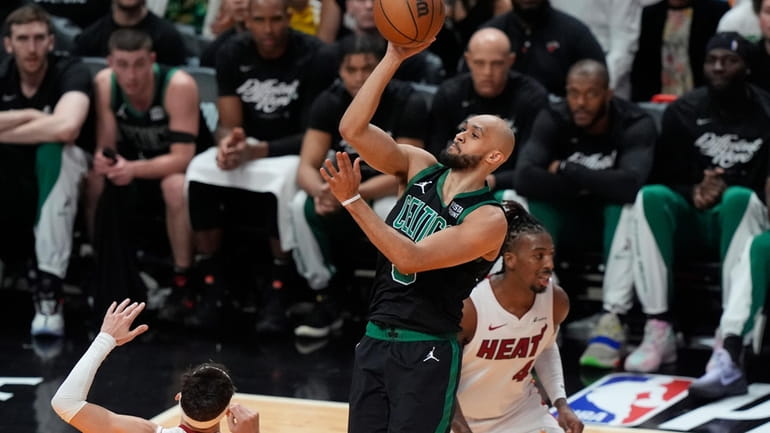 Boston Celtics guard Derrick White (9) scores over Miami Heat...