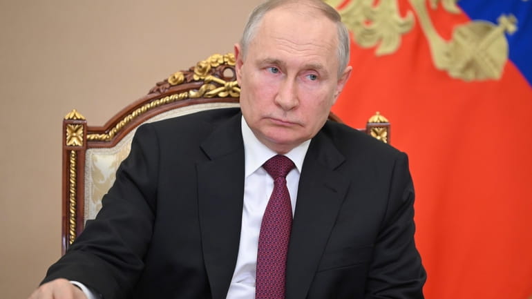 Russian President Vladimir Putin attends a cabinet meeting via video...