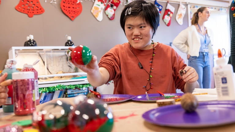 Maggie Shi makes Christmas ornaments at Jericho High School on...