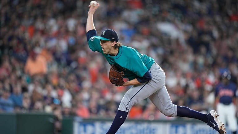 Seattle Mariners starting pitcher Logan Gilbert delivers during the first...