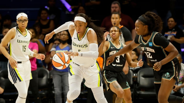 Dallas Wings forward Kayla Thornton, second from left, steals the...